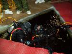 Capt Kilburn (left) conducts a leak check on Spr Plourde’s system.