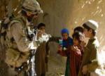 Canadian soldier giving Izzy Dolls to Afghan chidlren