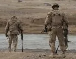 A typical engineer clearance operation on foot with mine detectors at a ford or crossing place.