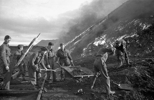 Sappers of the 3rd Field Company, Royal Canadian Engineers, burning coal piles during Operation Gauntlet (taken by Ross Munro)