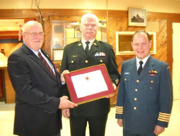 Col J.C. Benninger, 19 Wing Comox Commander and CWO K.P. Jones, CME Branch CWO, are presenting CWO D.N.F. Shavalier (Ret’d) with a CME Branch Commendation (certificate no 024) at the 192 CEF Aldergrove combined Mess on 15 December 2011.