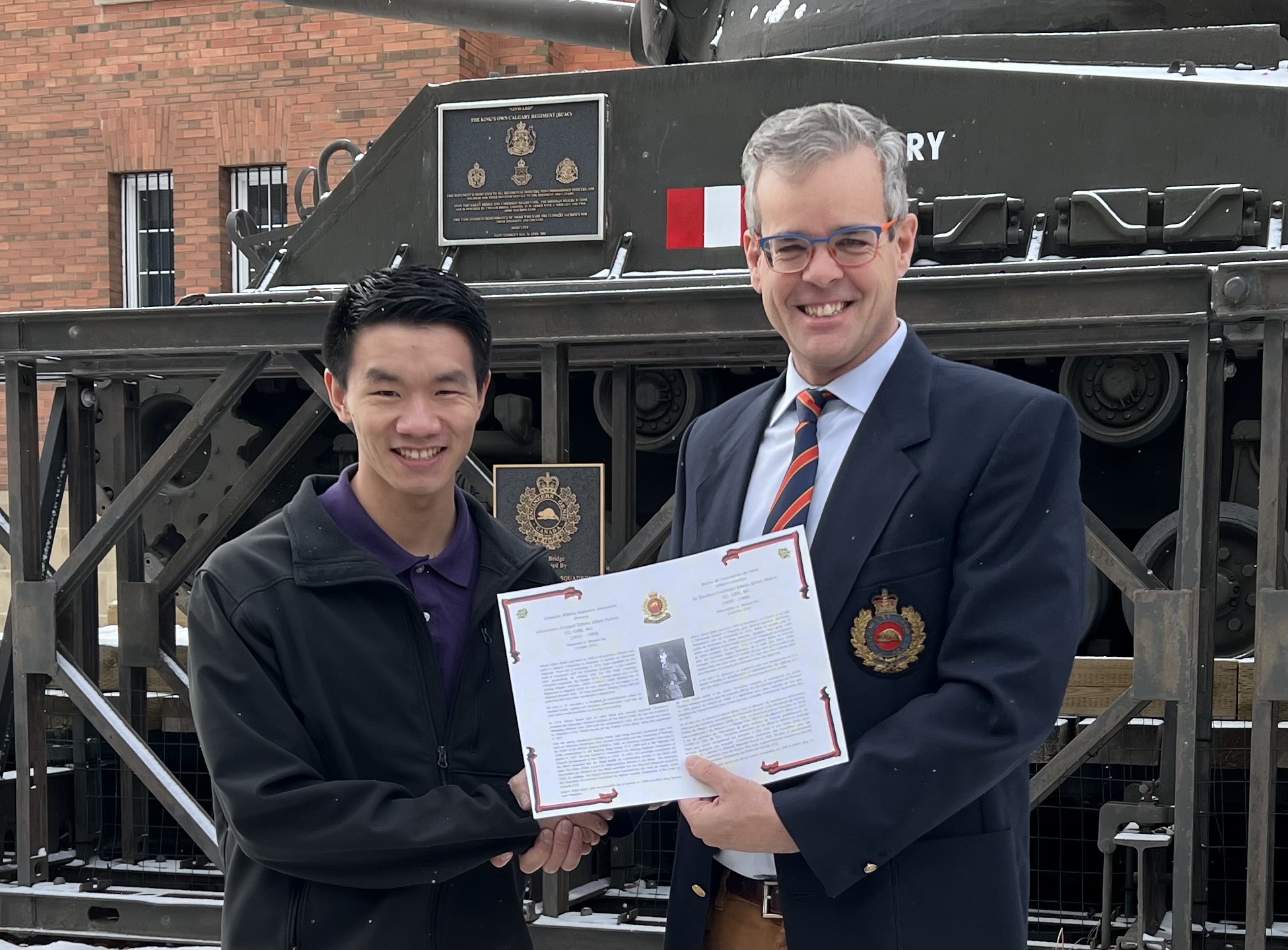 Benson Du  accepts 2022 CMEA Bursary from Col Eppo van Weelderen (Ret'd).jpg