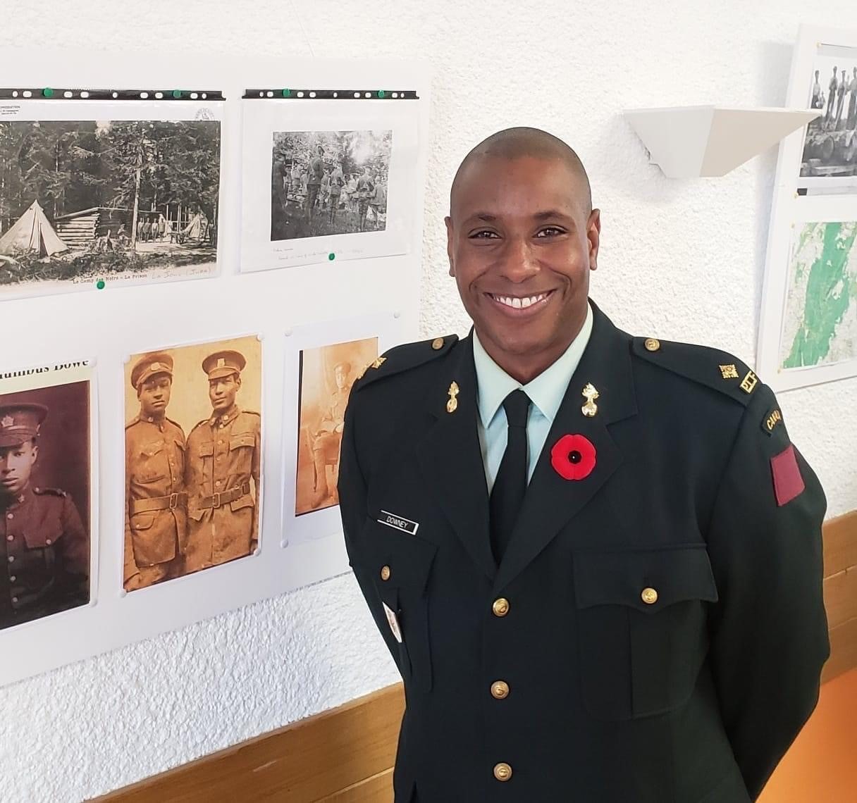 2Lt Downey in front of a picture in France of his great grandfather Spr George Downey