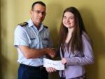 Erin Aucoin, daughter of LCol R.J. Aucoin (Ottawa), receiving the bursary cheque from her father.