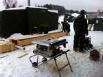 Carpenter at work, building a warm-air duct for pipes for MECCs used for ablutions