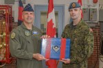 Brigadier General (USAF) Chad Manske promotes MCpl Brandon Terry