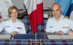 Col Darlene Quinn, Comd CF RP Ops Gp, and Col Thomas Dunne, Comd 19 Wing Comox, sign documents securing the transfer of all real property to ADM(IE) on April 9, 2015. Photo by 19 Wing Comox Imagery. // Le Col Darlene Quinn, cmdt du Gp Op Imm FC et le Col Thomas Dunne, cmdt de la 19e Escadre Comox, signent les documents concrétisant le transfert de tous les biens immobiliers au SMA(IE) le 9 avril 2015. Photo : Section de l’imagerie de la 19e Escadre Comox.