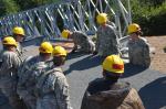 During Op Northern Frontier,soldiers from the U.S. 652nd Engineer Company out of Hammond, WI work as a team to build a bridge. The bridge project was one of five construction projects completed by the operation’s end. PHOTO: William P. Cynecki // Pendant l’opération Northern Frontier, des soldats de la U.S. 652nd Engineer Company de Hammond, au WI, travaillent en équipe pour construire un pont. Le pont était l’un des cinq projets de construction complétés à la fin de l’opération. PHOTO : William P. Cynecki