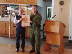 Dennis Dwyer receives an engraved plaque from the Edmonton Chapter of the CMEA