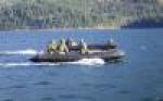 An assault boat from 39 Combat Engineer Regiment parallels the vehicle raft during a crossing of Cultus Lake during Exercise Worthy Sapper on 21 Feb 2015. 