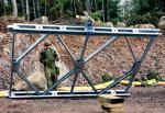 Cpl Jim Charlebois guides a bridge section down as members of 4 ESR continue to work on the construction of the Acrow bridge. Photo: WO Jerry Kean/5 Cdn Div HQ Public Affairs
