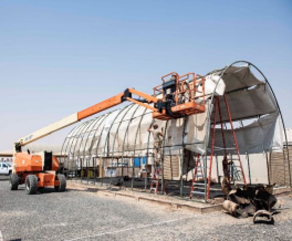 CE TP members using an articulated boom lift to erect an RTC structure.