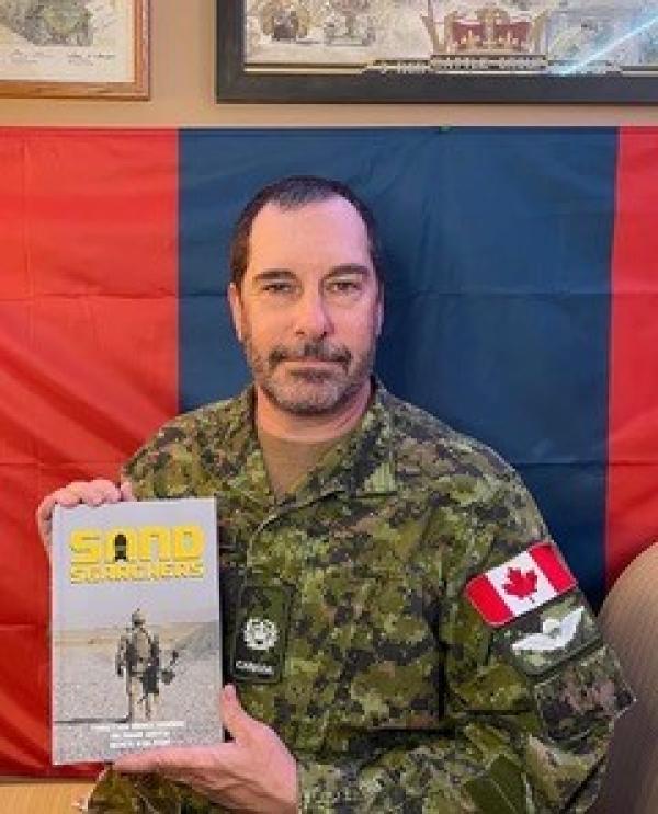 MWO Tim MacCormac with his book "Sand Searchers"