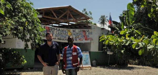 Stephane Michaud and former Op HESTIA interpreter Frandy Saint Val in front of the HELP Hospital and Nursing School built by 55 Support Squadron in only a few days.