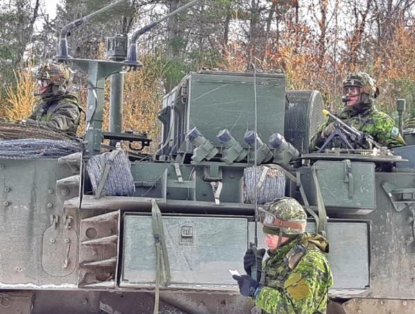 Photo 1 A Combat Engineer radios in the outcome of an enemy attack on a vehicle inspection point during Ex MATTAWA SAPPER, Nov 18