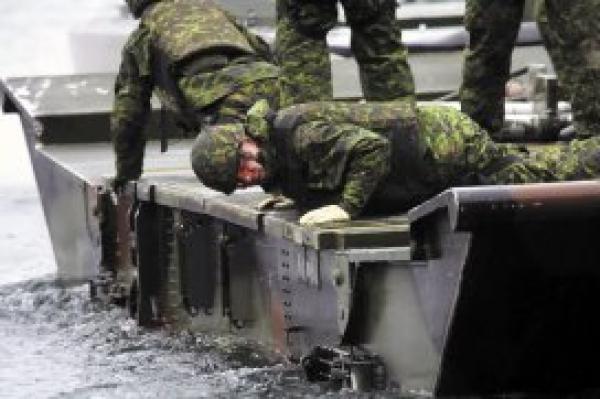 Reserve combat engineers were given hands-on training in bridge building during Exercise PALADIN RESPONSE. The medium raft or medium floating bridge is assembled on water and once the pieces are secure, it can be used to ferry large military vehicles from the water to land. - Photo: Sgt Greg Gorecki/41 CER