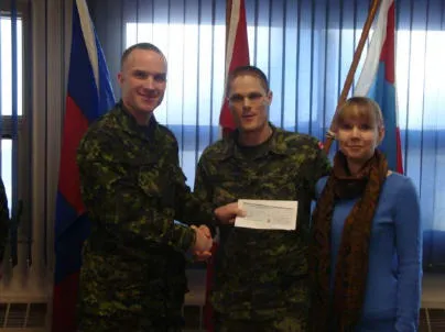 Leila-Ann Fife-McGinn daughter of WO McGinn (Winnipeg). Pictured are Leila-Ann’s parents receiving the bursary cheque on behalf of their daughter from Maj S. Ivanko.