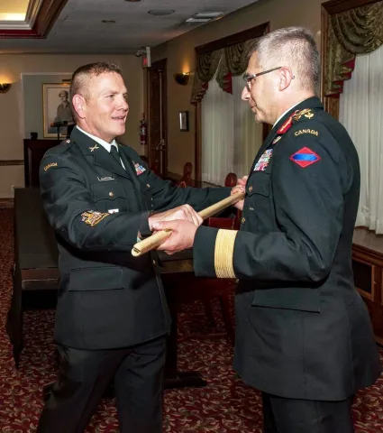 CWO Alain Guimond returns his pace stick to LGen Paul Wynnyk at the Change of Appointment Ceremony. Photo By: O/S Camden Scott, D of Army Public Affairs
