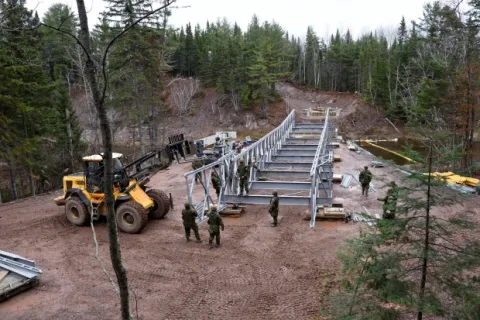 Combat Engineers work on the construction of the new recreational vehicle bridge across the Tetagouche River. (5th Canadian Division/Contributed)/Des sapeurs de combat travaillent à la construction du nouveau pont pour véhicules récréatifs traversant la rivière Tetagouche. (Photo : contribution de la 5e Division du Canada)