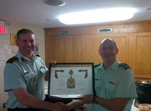 Col Basinger, Director RCE, presenting Maj Reynders with his certificate of service