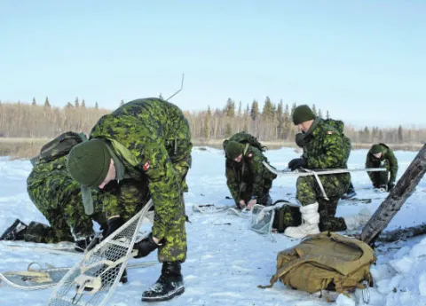 Soldiers from 41 Combat Engineer Regiment (41 CER) prepare to head out to confirm navigation skills during Exercise SURVIVING SAPPER in Cooking Lake, Alberta, from January 22-24,2016.