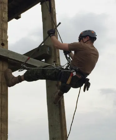 Cpl Fugere of 2 Combat Engineer Regiment works to remove the last decking board while stabilizing between two supports // Le Cpl Fugere du 2e Régiment de génie de combat s’affaire à retirer la dernière planche tout en se stabilisant entre deux poutres