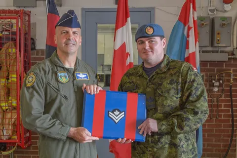 Brigadier General (USAF) Chad Manske promotes MCpl Ryan Moore