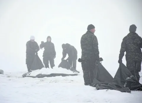 Soldiers from 41CER move snow as part of the building snow defences portion of Exercise SURVIVING SAPPER in Cooking Lake. Alberta, from January 22-24. 2016.