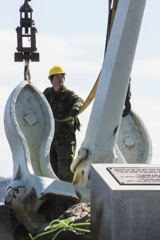 Members of 144 and 143 Construction Engineering Flight, based out of Pictou and Bridgewater, conducted the repair work on the Bonaventure Memorial, and used a crane on March 19 to connect the anchor to the newly built metal mounts.  Photo: Ryan Melanson, Trident