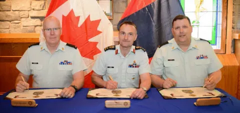 CWO G. Simpkin, CD (Incoming CME Branch CWO), MGen J.S. Sirois, OMM, CD (CAF Chief Military Engineer) and CWO R.G. Swift, CD (Outgoing CME Branch CWO) signing the Branch CWO change of appointment certificate