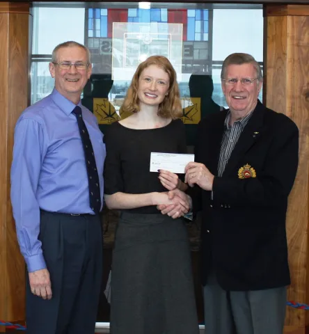LCol Ralph Gienow (ret'd) presents a cheque to Valerie Moore with her father, CMEA member Maj T.A.P.Moore (Ret'd), standing by.
