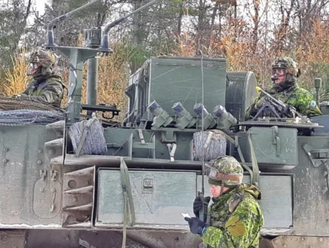 Photo 1 A Combat Engineer radios in the outcome of an enemy attack on a vehicle inspection point during Ex MATTAWA SAPPER, Nov 18