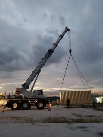 Sea Containers of Construction Material from Canada being delivered to OSH LAC Prior to Construction