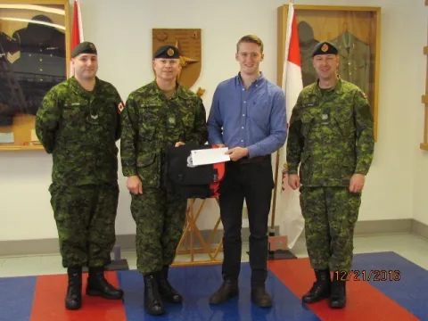 Tyler Snook receives CMEA Bursary Cheque from CMEA Chapter President, MWO Shawn Stoot: Left to Right: Cpl Levi Malmas, MWO Shawn Sloot, Tyler Snook, MWO Bill Lovely