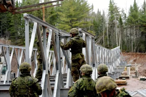 Soldiers secure pieces of the Acrow bridge they constructed during Exercise Nihilo Sapper, a construction engineering exercise that took place in Bathurst, N.B. Photo: WO Jerry Kean/5 Cdn Div HQ Public Affairs